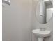 Bright bathroom featuring a white sink, stylish faucet, and an elegant round mirror at 935 E Redondo Dr, Gilbert, AZ 85296