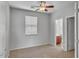 Cozy bedroom with neutral carpeting, a ceiling fan, and access to an en-suite bathroom at 935 E Redondo Dr, Gilbert, AZ 85296