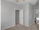 Neutral bedroom with carpet floors, ceiling fan, and an adjoining bathroom at 935 E Redondo Dr, Gilbert, AZ 85296