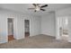 Large bedroom featuring a ceiling fan and multiple entryways to closet and bathroom at 935 E Redondo Dr, Gilbert, AZ 85296