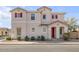 Two story home with red door and red shutters, beige stucco and desert landscaping at 935 E Redondo Dr, Gilbert, AZ 85296