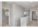 Hallway with a view into a bedroom, showcasing neutral walls and carpeted flooring at 935 E Redondo Dr, Gilbert, AZ 85296