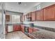 Kitchen with tile flooring, cherry wood cabinets, stainless steel dishwasher and oven at 935 E Redondo Dr, Gilbert, AZ 85296