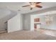 Open living room with ceiling fan, tile and carpet flooring and view to bar area at 935 E Redondo Dr, Gilbert, AZ 85296