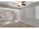 Open living room with ceiling fan, tile and carpet flooring and sliding glass door at 935 E Redondo Dr, Gilbert, AZ 85296