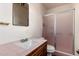 Modest bathroom featuring a tiled vanity and enclosed shower with simple fixtures at 1017 E Seldon Ln, Phoenix, AZ 85020