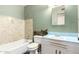 Dated bathroom includes a tub, toilet, and sink, highlighted by blue tiling accents at 1017 E Seldon Ln, Phoenix, AZ 85020