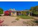 Charming single-story home with solar panels and colorful bougainvillea bushes at 1017 E Seldon Ln, Phoenix, AZ 85020