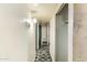 Long hallway with linoleum flooring and basic lighting, with doors leading to other rooms at 1017 E Seldon Ln, Phoenix, AZ 85020