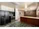 Spacious kitchen featuring tiled floors, white cabinets, and black appliances at 1017 E Seldon Ln, Phoenix, AZ 85020
