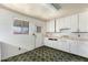 Kitchen featuring tiled floors, white cabinets, and a stainless steel sink at 1017 E Seldon Ln, Phoenix, AZ 85020