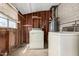 Functional laundry area showing a washer, dryer, and exposed wall studs for utility at 1017 E Seldon Ln, Phoenix, AZ 85020