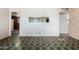 Unfurnished living room featuring tiled floors, white walls, and an inset mirror at 1017 E Seldon Ln, Phoenix, AZ 85020
