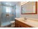 Bathroom features a vanity with wood cabinetry and a glass shower enclosure at 10437 E Boulder Dr, Apache Junction, AZ 85120