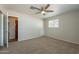 Bright bedroom with new carpet, ceiling fan, and good natural light at 10437 E Boulder Dr, Apache Junction, AZ 85120