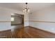 Dining room featuring hardwood floors and decorative lighting fixture at 10437 E Boulder Dr, Apache Junction, AZ 85120
