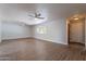 A bright living room with hardwood floors, ceiling fans, and natural light at 10437 E Boulder Dr, Apache Junction, AZ 85120