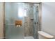Bathroom shower with glass doors, storage shelves, and accessibility features at 10437 E Boulder Dr, Apache Junction, AZ 85120