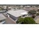 Aerial view of a well-maintained home with a tiled roof, covered patio, and desert landscaping at 11003 E Kiva Ave, Mesa, AZ 85209