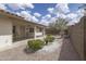 Charming backyard with gravel and stone landscaping featuring a covered patio and relaxing fountain at 11003 E Kiva Ave, Mesa, AZ 85209