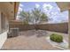 Backyard with desert landscaping and a mature shade tree at 11003 E Kiva Ave, Mesa, AZ 85209
