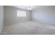 Neutral carpeted bedroom with ceiling fan, light walls, and shuttered window at 11003 E Kiva Ave, Mesa, AZ 85209