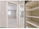 Walk-in closet featuring mirrored door leading into the carpeted bedroom at 11003 E Kiva Ave, Mesa, AZ 85209