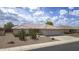 Charming single-story home featuring a well-manicured front yard, a tile roof, and a three-car garage at 11003 E Kiva Ave, Mesa, AZ 85209