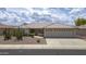 Charming single-story home featuring a well-manicured front yard, a tile roof, and a three-car garage at 11003 E Kiva Ave, Mesa, AZ 85209