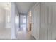 Bright hallway featuring neutral paint, tiled floors, and a chandelier for a welcoming entry at 11003 E Kiva Ave, Mesa, AZ 85209