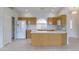 Bright kitchen featuring white appliances, a peninsula counter, and light wood cabinetry at 11003 E Kiva Ave, Mesa, AZ 85209