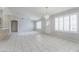 Bright living room features tiled floors, neutral walls, and large windows with shutters at 11003 E Kiva Ave, Mesa, AZ 85209