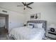 This bedroom offers soft lighting, a ceiling fan and a plush upholstered headboard at 1247 W Boxelder Cir, Chandler, AZ 85224