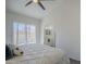 Bright bedroom featuring vaulted ceiling, ceiling fan, large sliding glass doors and an ensuite bathroom at 1247 W Boxelder Cir, Chandler, AZ 85224