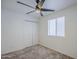 Bedroom with neutral carpet, ceiling fan, closet and window at 1247 W Boxelder Cir, Chandler, AZ 85224