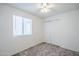 Bright bedroom with neutral carpet, ceiling fan, and closet at 1247 W Boxelder Cir, Chandler, AZ 85224