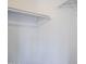 A close up view of a white closet with hanging racks at 1247 W Boxelder Cir, Chandler, AZ 85224