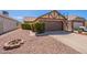 Charming single-story home showcasing a well-manicured yard and a two-car garage at 1247 W Boxelder Cir, Chandler, AZ 85224