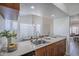 Bright eat-in kitchen with stainless steel sink and quartz countertops at 1247 W Boxelder Cir, Chandler, AZ 85224