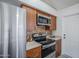 Modern kitchen featuring stainless steel appliances and wood cabinetry at 1247 W Boxelder Cir, Chandler, AZ 85224