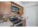 Well-equipped kitchen with stainless steel oven and tile backsplash at 1247 W Boxelder Cir, Chandler, AZ 85224