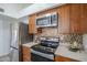 Modern kitchen featuring stainless steel appliances and mosaic backsplash at 1247 W Boxelder Cir, Chandler, AZ 85224