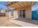 A covered patio extends from the home, featuring sliding glass doors and a concrete floor at 1247 W Boxelder Cir, Chandler, AZ 85224