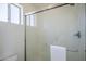This bathroom showcases a sleek frameless glass shower with a white towel hung on the door at 1247 W Boxelder Cir, Chandler, AZ 85224