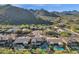 An aerial view shows homes with backyard pools in a desert community with mountain vistas at 13827 N Mesquite Ln, Fountain Hills, AZ 85268