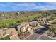 High angle view shows houses in a golf course neighborhood, set against a scenic mountain backdrop on a clear day at 13827 N Mesquite Ln, Fountain Hills, AZ 85268
