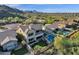 Overhead shot of a home with a putting green and pool, nestled in a scenic mountain community at 13827 N Mesquite Ln, Fountain Hills, AZ 85268