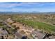 Vast aerial view shows homes by a golf course and stunning mountain backdrop, emphasizing the neighborhood's beauty at 13827 N Mesquite Ln, Fountain Hills, AZ 85268
