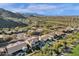 Extensive aerial view of a serene neighborhood adjacent to a golf course, framed by majestic mountains at 13827 N Mesquite Ln, Fountain Hills, AZ 85268