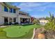 Expansive backyard featuring a putting green, lush landscaping, and a patio for outdoor enjoyment at 13827 N Mesquite Ln, Fountain Hills, AZ 85268